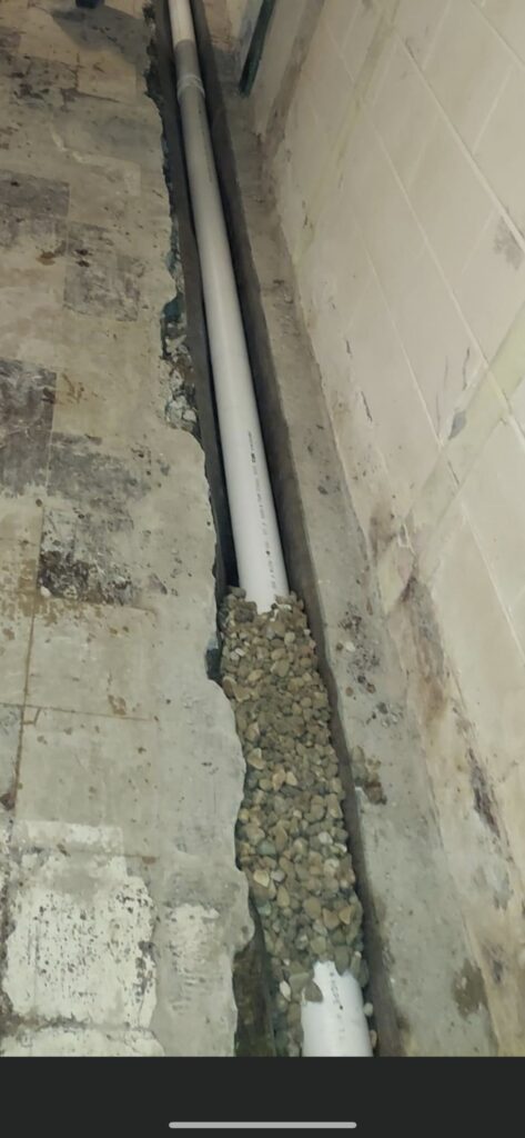 soil separating fabric is placed under the pipe with stone holding it in place scaled