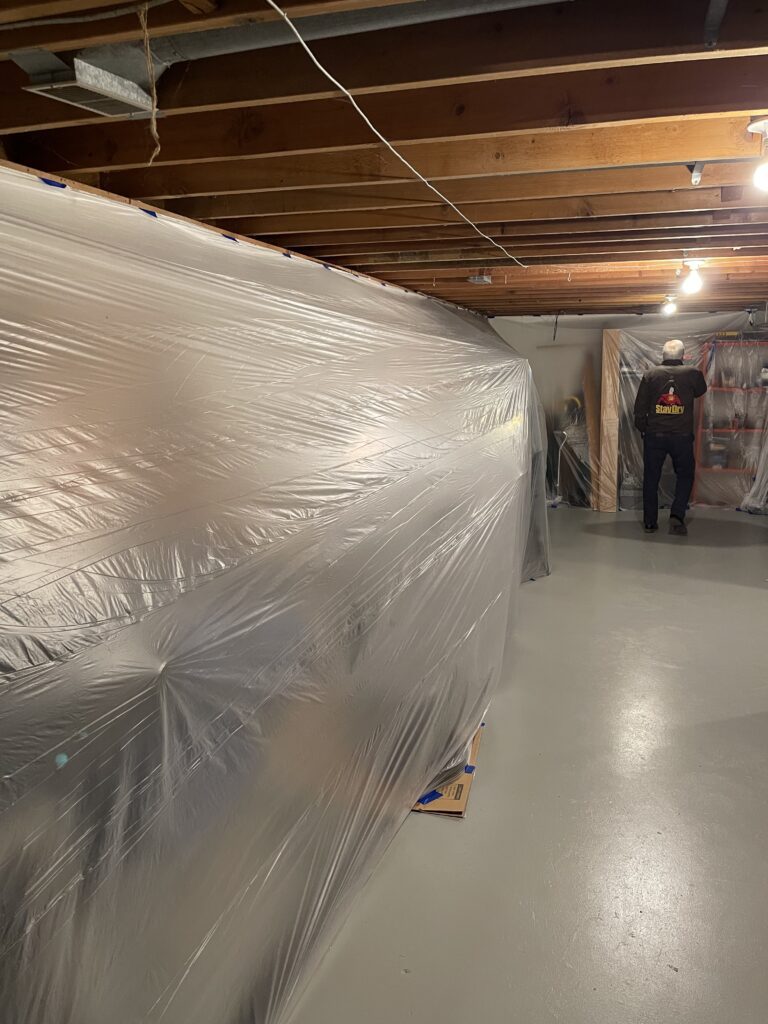 basement belongings are covered in plastic to protect them