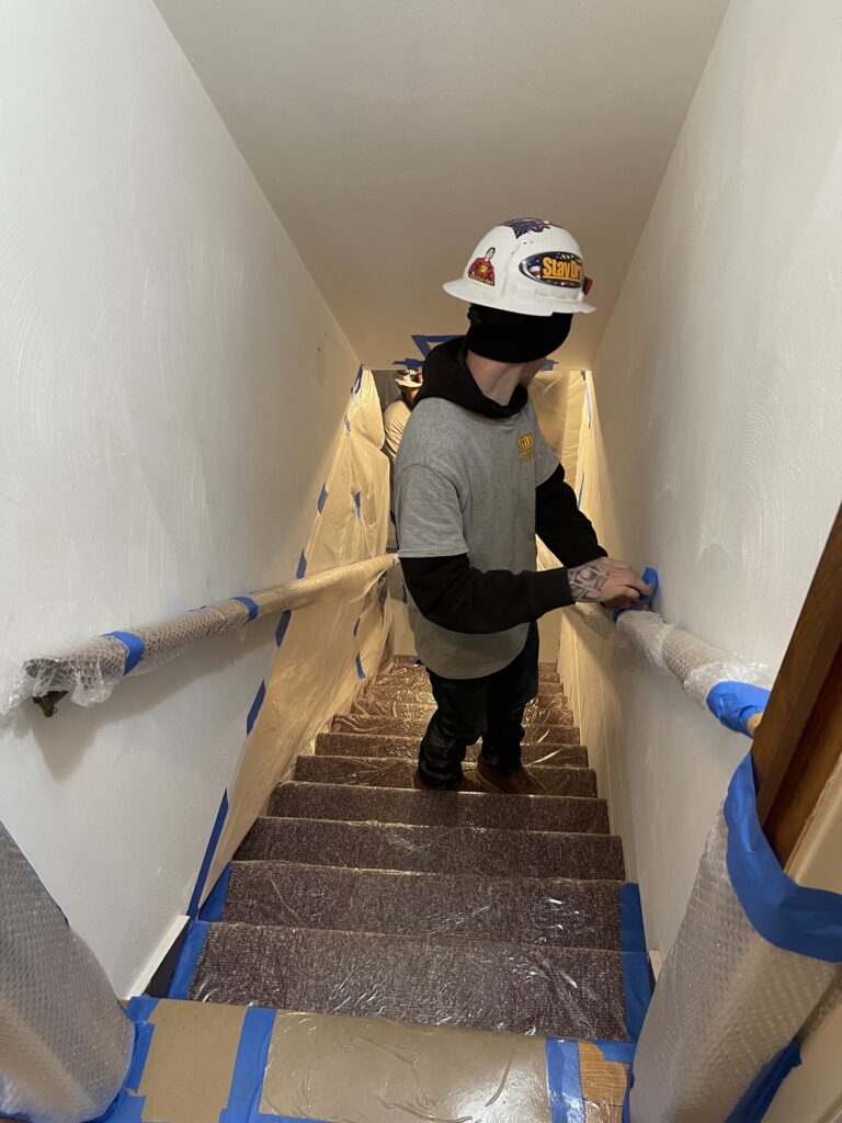 StayDry Worker Prepping the Stairs With Protective Wrap